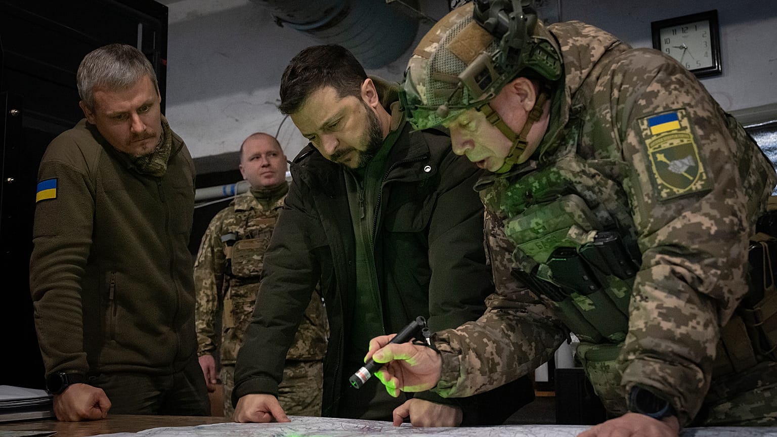 Ukrainian President Volodymyr Zelenskyy, Commander of Ukraine's Ground Forces Col.-Gen. Oleksandr Syrski, right, visit the front line city of Kupiansk on Nov. 30, 2023.