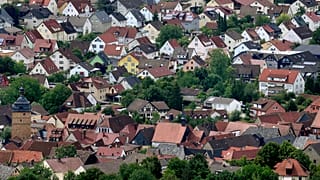 Residential houses in the town of Bad Staffelstein are pictured from the Staffelberg hill in Germany