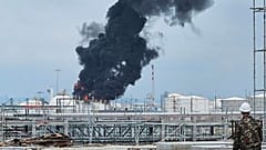 Black smoke billows after an explosion at the gas storage tanks in an industrial area in Rayong province, eastern of Thailand, Thursday, May 9, 2024.