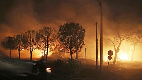 Buildings burn in the town of Mati, east of Athens, Greece, Monday, July 23, 2018. 