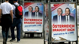 People pass by damaged election posters showing former Austrian Vice Chancellor and Interior Minister Heinz-Christian Strache, right in Vienna, Sunday, May 26, 2019. 