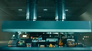 A hydraulic press crushes an array of creative instruments in a still from Apple's new ad