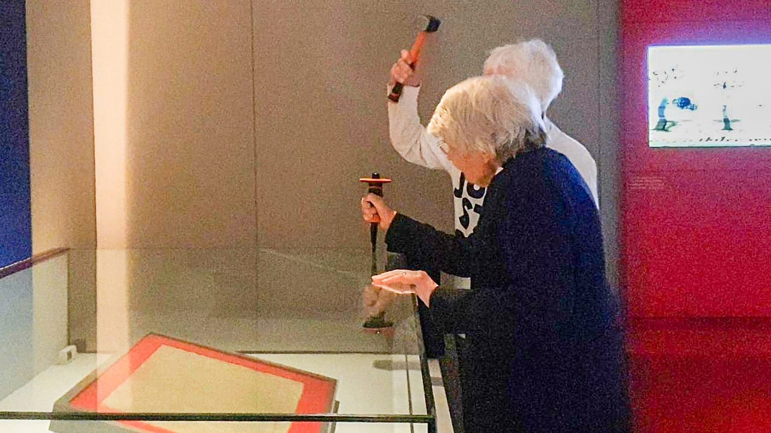 Just Stop Oil supporters Judy Bruce, 85, and Reverend Sue Parfitt, 82, attempt to smash the protective enclosure.