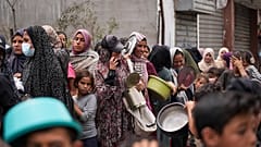 Palestinians line up for food distribution in Deir al Balah, Gaza, Friday, May 10, 2024.