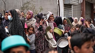 Palestinians line up for food distribution in Deir al Balah, Gaza, Friday, May 10, 2024.