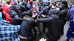 Police try to detain demonstrators near the Parliament building during an opposition protest against "the Russian law" in Tbilisi, Georgia, on Monday, May 13, 2024.