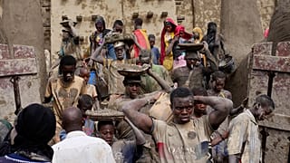 Malians take part in the annual replastering of the world's largest mud-brick building, the Great Mosque of Djenne, Mali, Sunday, May 12, 2024.