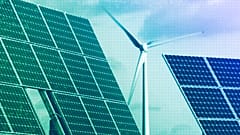 Photovoltaic modules and a windmill of the wind farm are pictured at the village of Feldheim near Berlin, November 2011