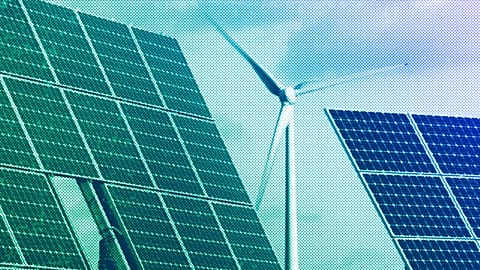 Photovoltaic modules and a windmill of the wind farm are pictured at the village of Feldheim near Berlin, November 2011