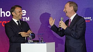 Microsoft CEO Brad Smith, right, speaks to French President Emmanuel Macron at the French Microsoft headquarters in Issy-les-Moulineaux, outside Paris. May 13, 2024. 