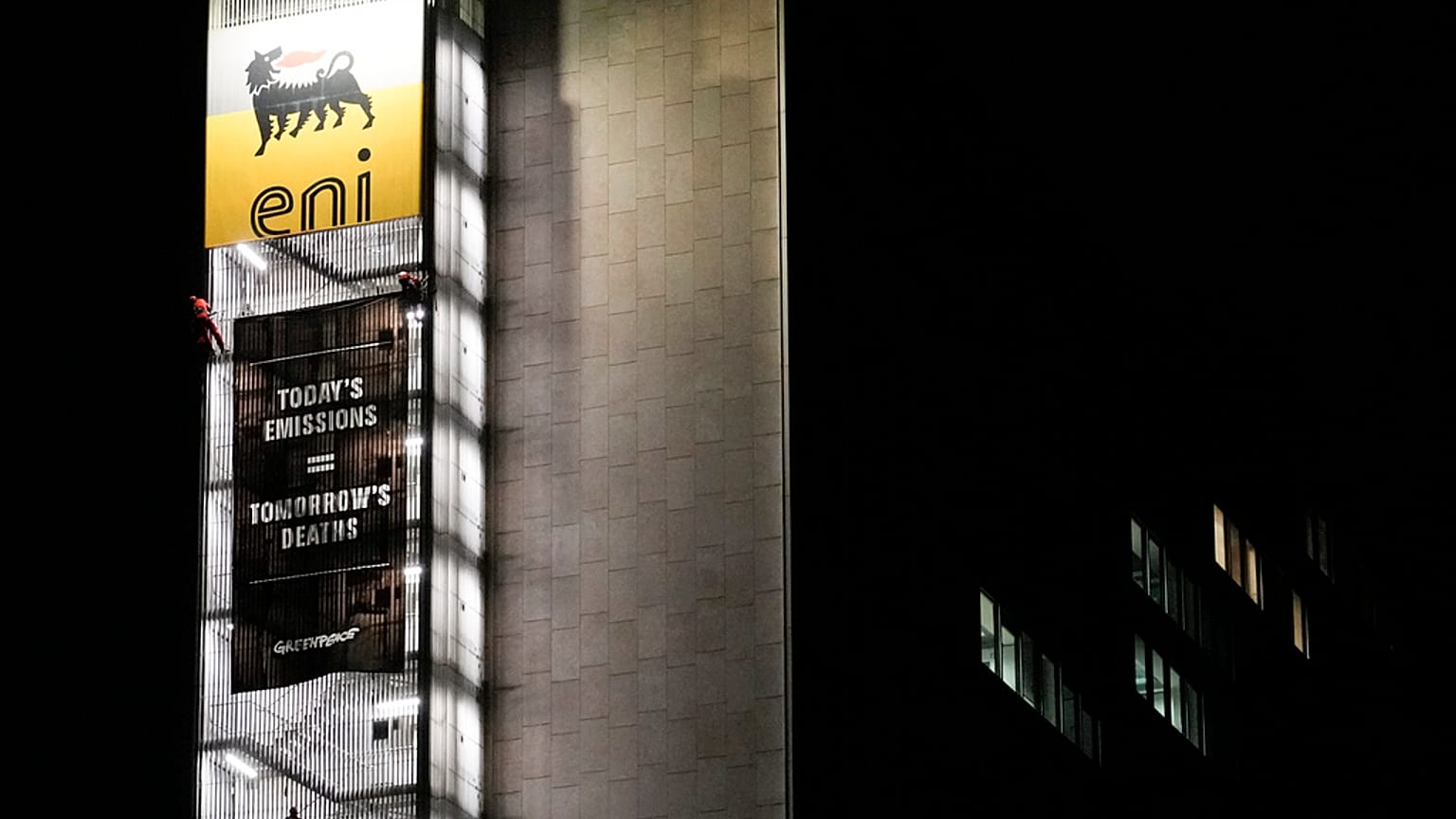 Greenpeace environmental organization activist unroll a banner on the ENI, Italian oil and gas company, headquarters building, in Rome, Tuesday, Dec. 5, 2023. 