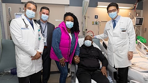 Rick Slayman sits with doctors from Massachusetts General Hospital and his partner.