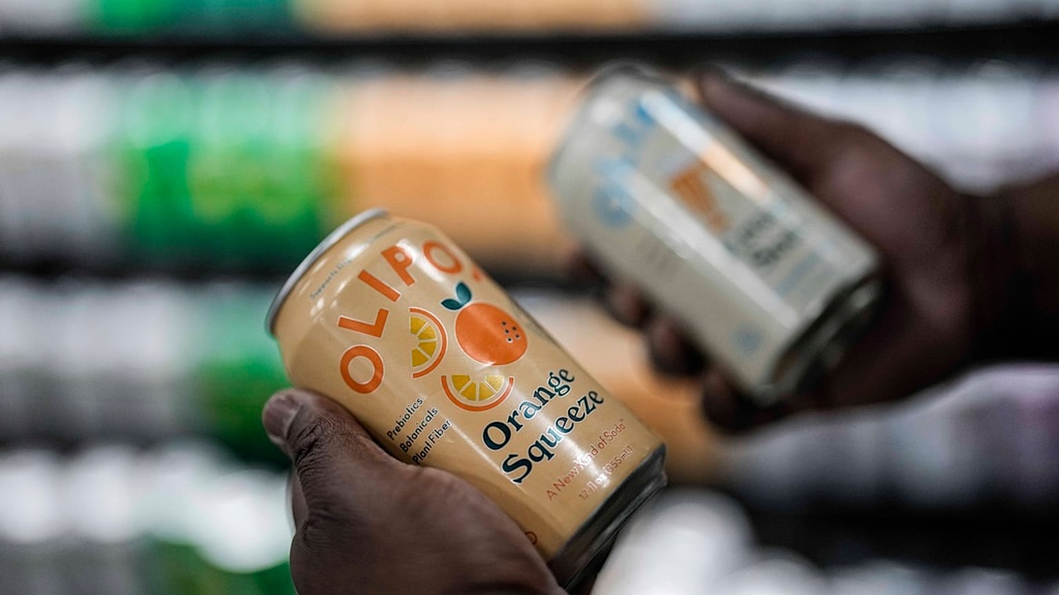 Cans of Olipop, a soda containing botanicals, plant fibers, and prebiotics, are shown at a Kroger supermarket, Friday, April 12, 2024, in Marietta, Ga. 