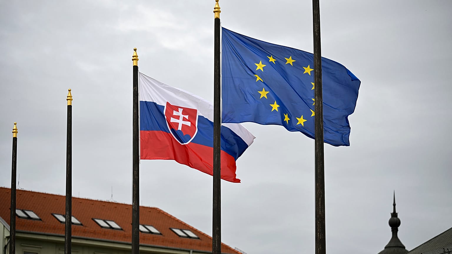 The Slovak national flag, left, flutters next to the flag of European Union in Bratislava
