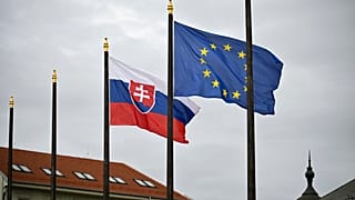 The Slovak national flag, left, flutters next to the flag of European Union in Bratislava