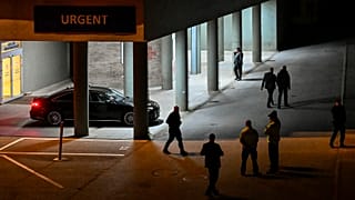 Police and officials stand outside the entrance of the emergency room of the Roosevelt Hospital in Banska Bystrica, 15 May 2024