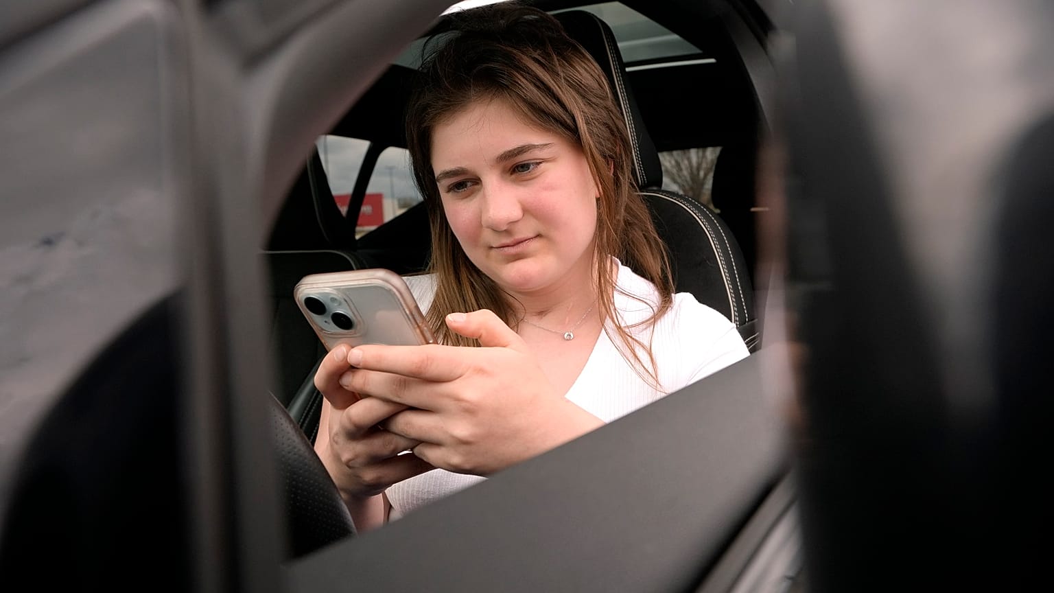 Alexis Bogan, whose speech was impaired by a brain tumour, uses an AI powered smartphone app to create a audible drink order at a Starbucks.