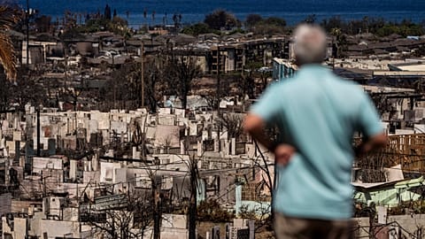 A man views the aftermath of a wildfire in Lahaina, Hawaii, August 19, 2023.