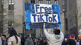 A man carries a Free TikTok sign in front of the courthouse where the hush-money trial of Donald Trump got underway April 15, 2024, in New York.
