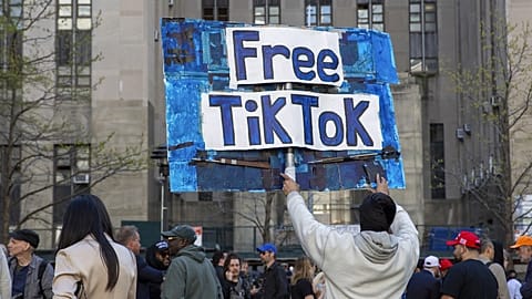 A man carries a Free TikTok sign in front of the courthouse where the hush-money trial of Donald Trump got underway April 15, 2024, in New York.