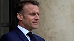 France's President Emmanuel Macron waits prior to welcoming Tanzania's President Samia Suluhu Hassan as part of the "Summit on Clean Cooking in Africa" at the Elysee President
