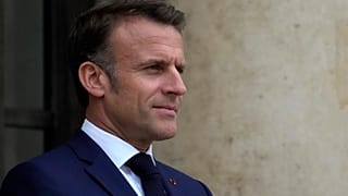 France's President Emmanuel Macron waits prior to welcoming Tanzania's President Samia Suluhu Hassan as part of the "Summit on Clean Cooking in Africa" at the Elysee President