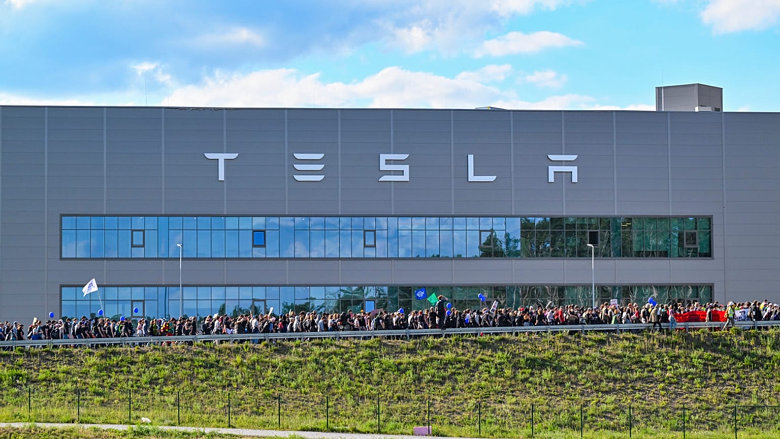Demonstrators walk past the Tesla factory in Gruenheide, Germany, May 11, 2024, at the end of their protest. 