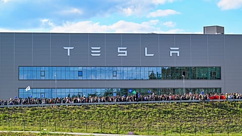 Demonstrators walk past the Tesla factory in Gruenheide, Germany, May 11, 2024, at the end of their protest. 