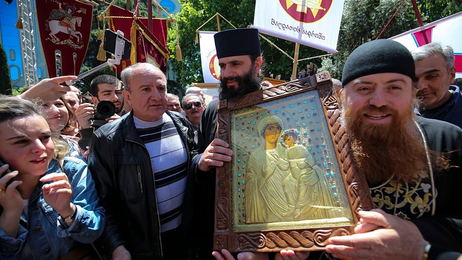 People and Georgian Orthodox Church priests gather to celebrate the Day of Family Purity in front of the Georgian Parliament's building in Tbilisi, Georgia