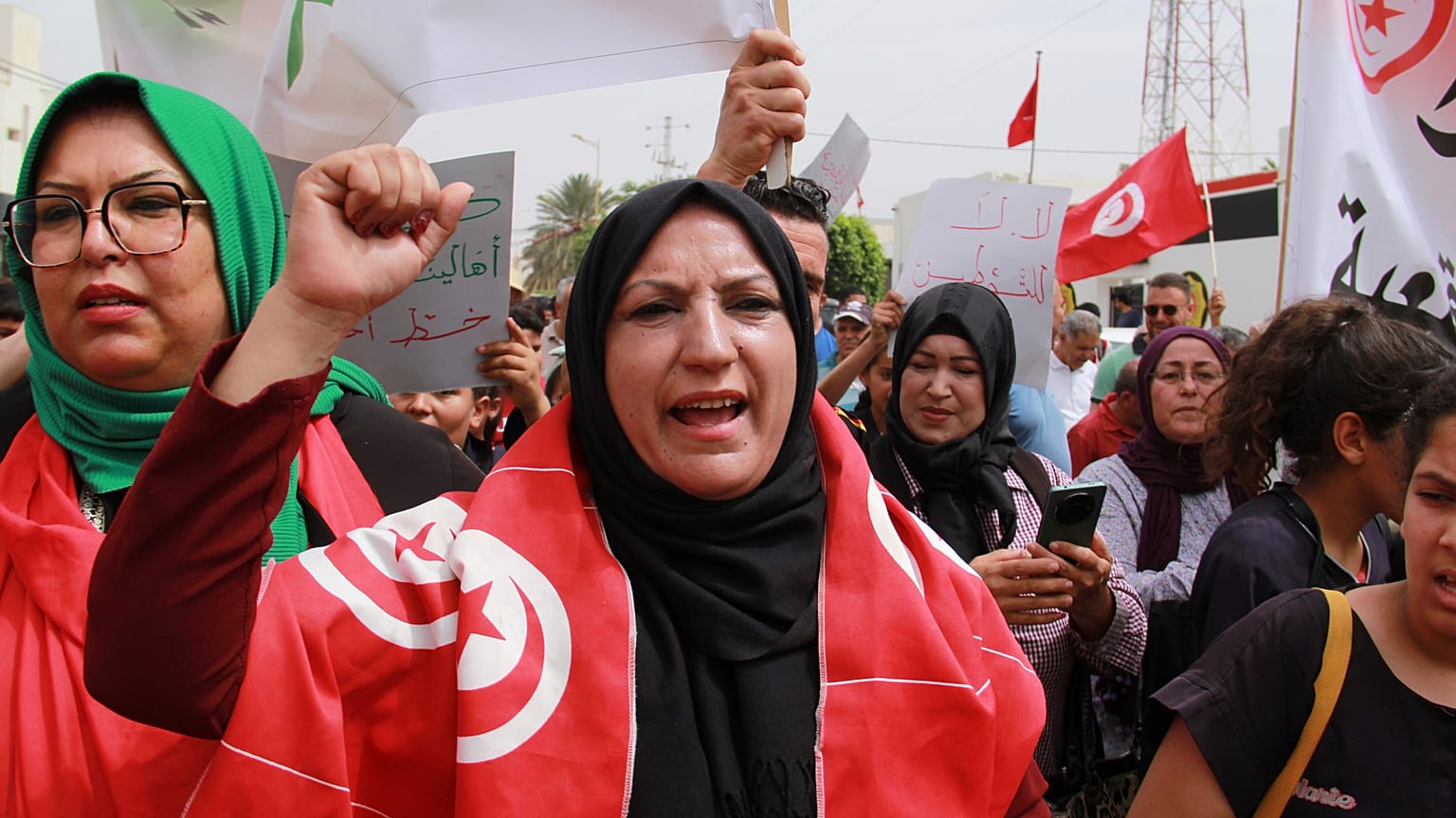 Tunisians take part in a protest against the presence of sub-Saharan migrants who have found themselves stranded in Jebeniana, Tunisia, Saturday, May 18, 2024.