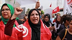 Tunisians take part in a protest against the presence of sub-Saharan migrants who have found themselves stranded in Jebeniana, Tunisia, Saturday, May 18, 2024.