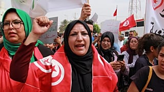 Tunisians take part in a protest against the presence of sub-Saharan migrants who have found themselves stranded in Jebeniana, Tunisia, Saturday, May 18, 2024.