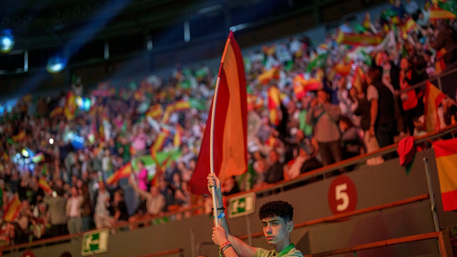 A supporter holds a Spansh flag during the Spanish far-right wing party Vox's rally "Europa Viva 24" in Madrid, Spain, Sunday, May 19, 2024.
