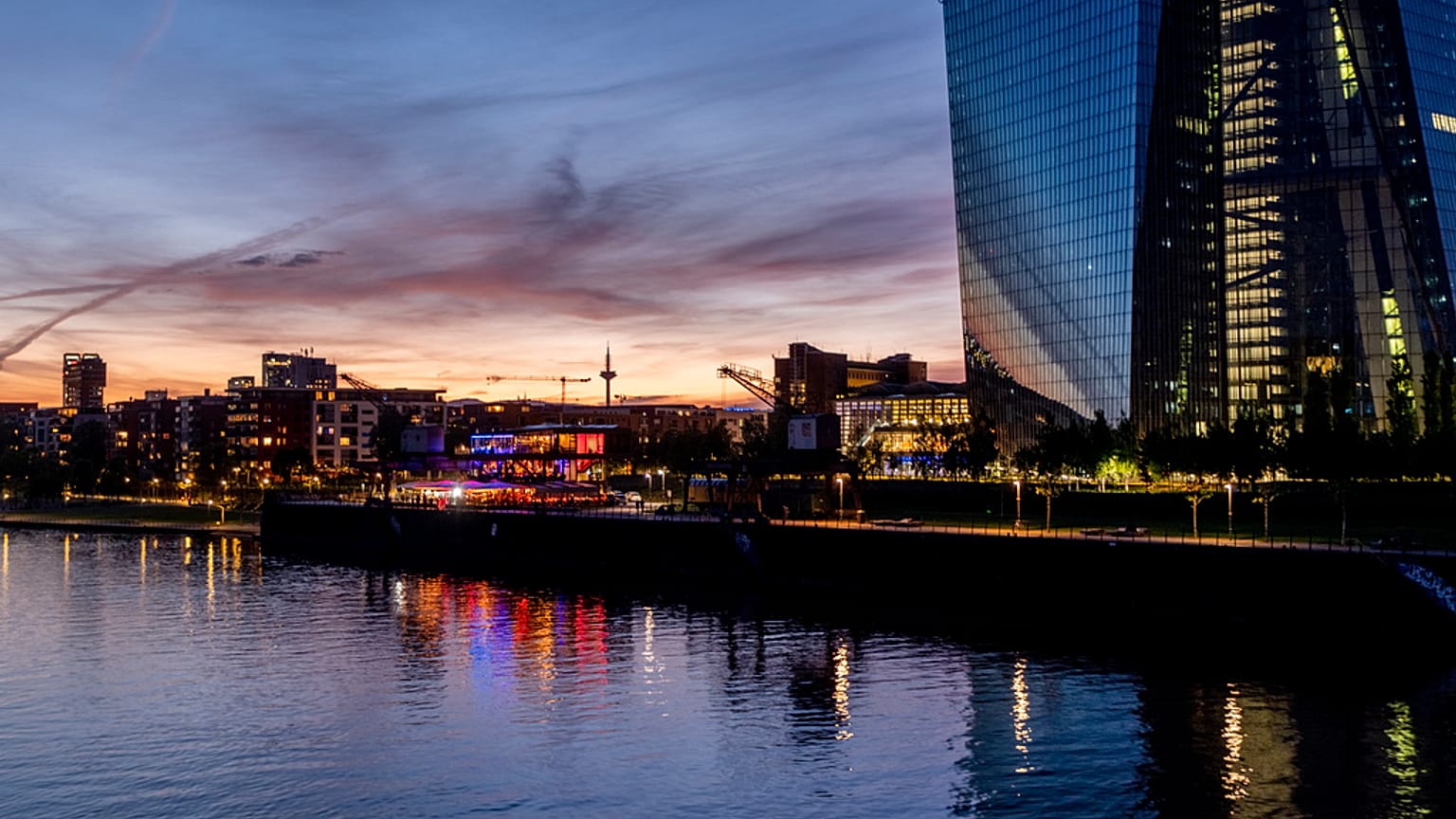Colourful lights burn in the window of a restaurant near the European Central Bank, right, in Frankfurt, Germany, late Friday, May 3, 2024.