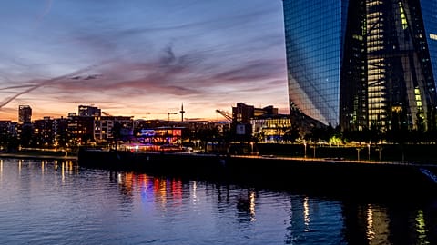 Colourful lights burn in the window of a restaurant near the European Central Bank, right, in Frankfurt, Germany, late Friday, May 3, 2024.