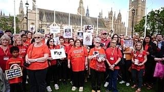 Infected blood campaigners gather in Parliament Square, ahead of the publication of the final report into the scandal, in London.