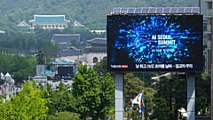 A screen shows an announcement of the AI Seoul Summit in Seoul, South Korea.