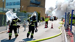 Firefighters work to extinguish a fire at the Novo Nordisk headquarters in Bagsvaerd, near Copenhagen, Denmark.