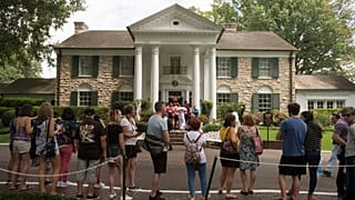 Fans wait in line outside Graceland Tuesday, Aug. 15, 2017, in Memphis, Tenn.
