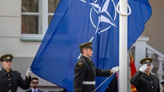 Soldiers stand for a flag-raising ceremony during a celebration for Lithuania's NATO membership 20th anniversary in Vilnius, 29 March 2024