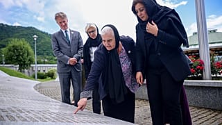 Nusrat Ghani walks with Munira Subasic next to the momument with the names of Srebrenica genocide victims in Potocari, Bosnia, Wednesday, May 22, 2024.