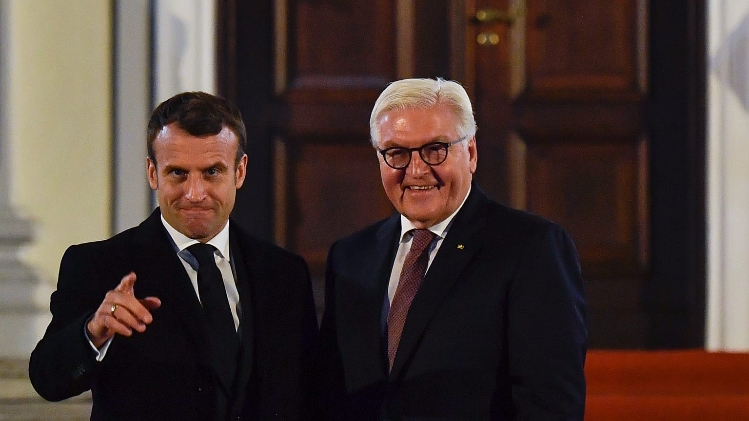 French President Emmanuel Macron, left, gestures as he is welcomed by German President Frank-Walter Steinmeier Sunday Nov. 10, 2019 at the presidential Bellevue Palace in Berl