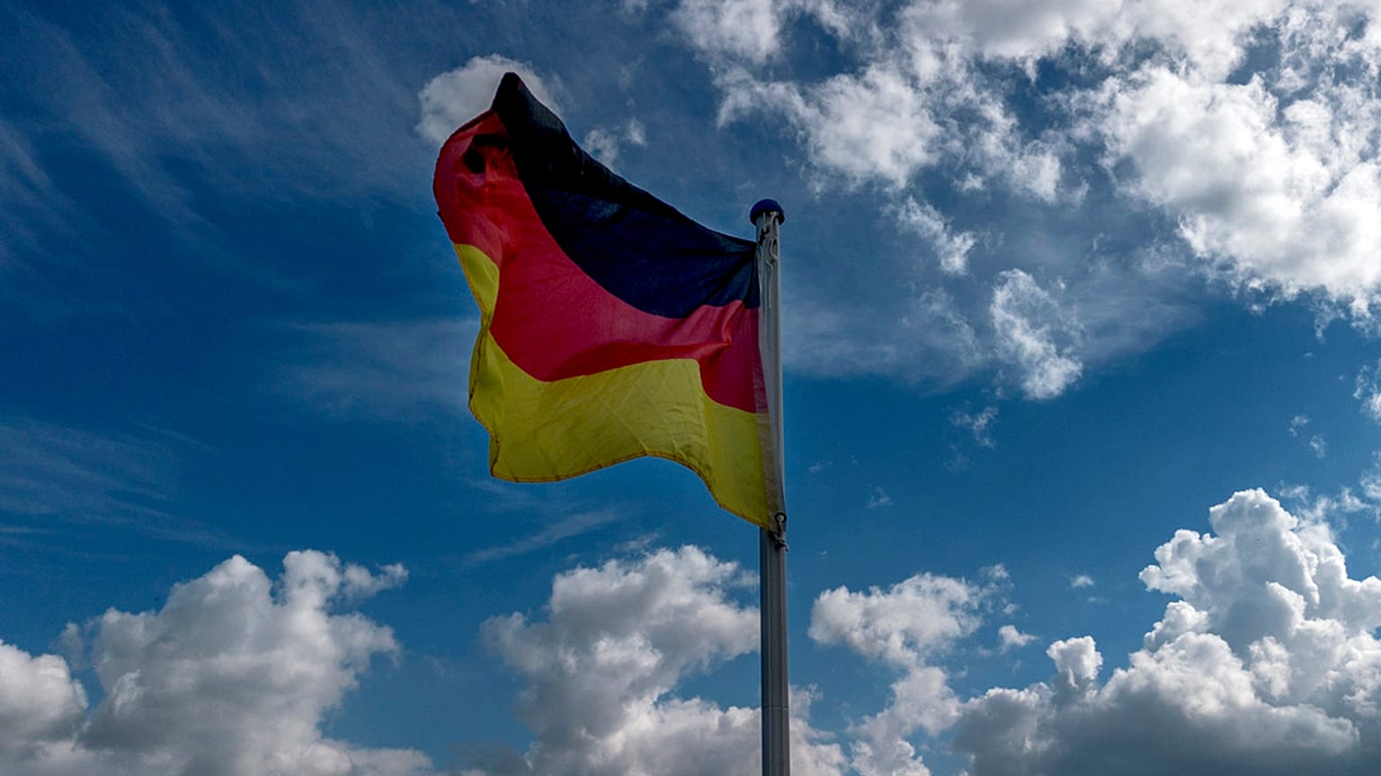 A German national flag waves on a field in the outskirts of Frankfurt, Germany, Wednesday, May 22, 2024. (AP Photo/Michael Probst)