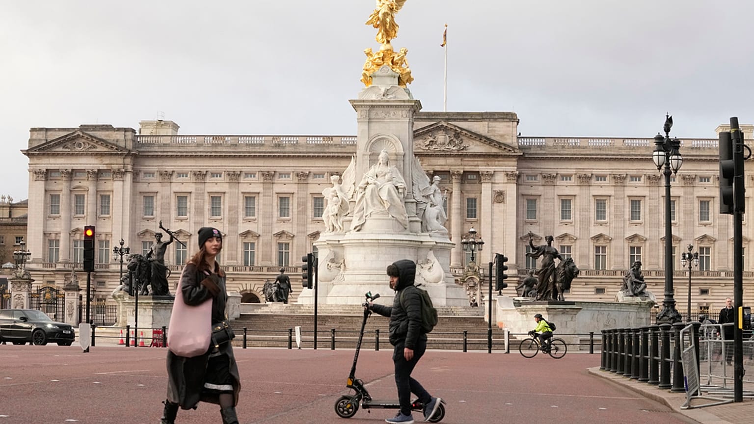 A general view of Buckingham Palace one, of the official residences of King Charles III, as pedestrians walk past in London, Tuesday, Feb. 6, 2024.