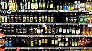 Olive oil bottles are seen in a supermarket in Rome, Friday, March 8, 2024.