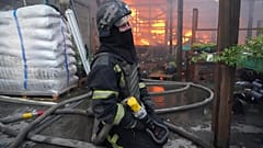 Bombeiro apaga incêndio em Kharkiv após ataque aéreo russo.