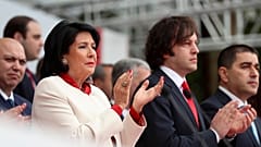 President Salome Zourabichvili, left, and Prime Minister Irakli Kobakhidze, right, attend a celebration for Independence Day in Tbilisi, May 26, 2024