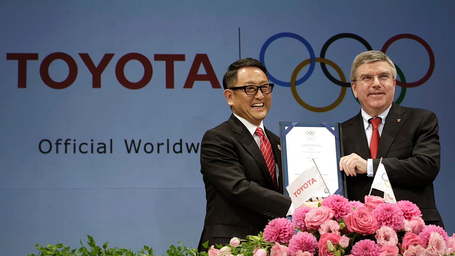 FILE - Toyota President and CEO Akio Toyoda, IOC President Thomas Bach