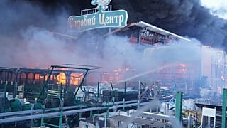 Firefighters put out a fire after two guided bombs hit a large construction supplies store in Kharkiv, Ukraine