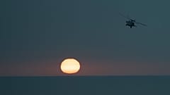 An MH-60S Seahawk helicopter flies back to the U.S.S. aircraft carrier Dwight D. Eisenhower, also known as the 'IKE', in the south Red Sea